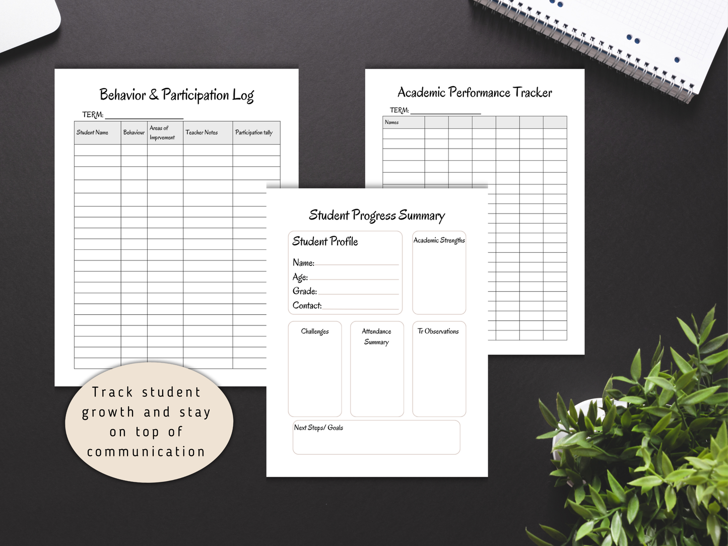 Educational tracking sheets on a black surface with a plant